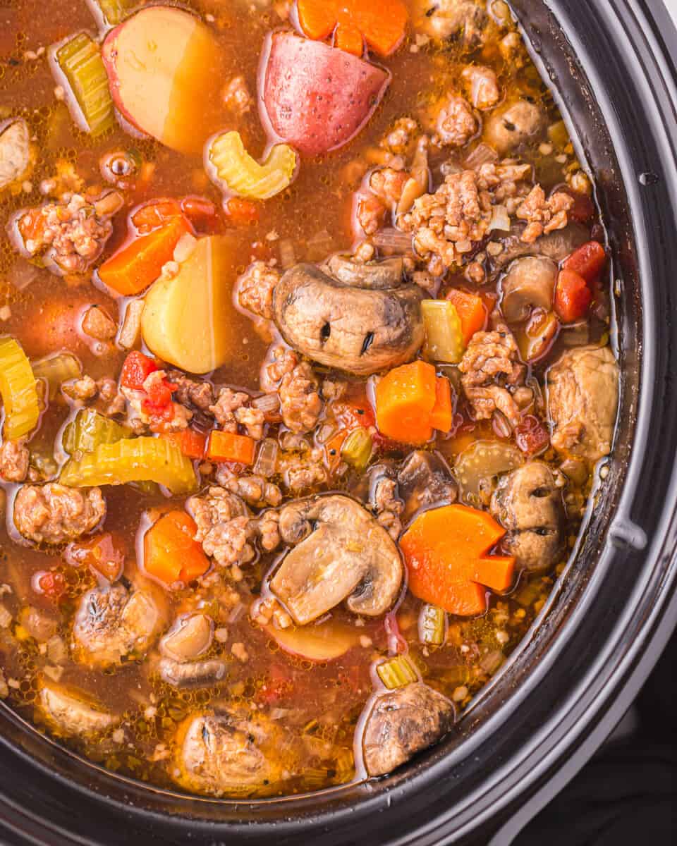 a crock pot full of meat and vegetables.