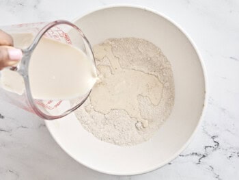 milk poured over dry ingredients in a bowl.