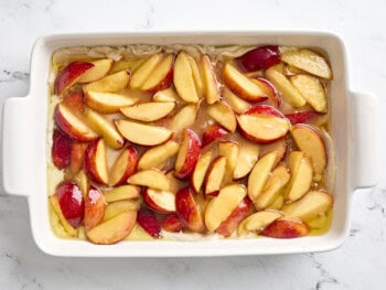 unbaked peach cobbler in a baking dish.