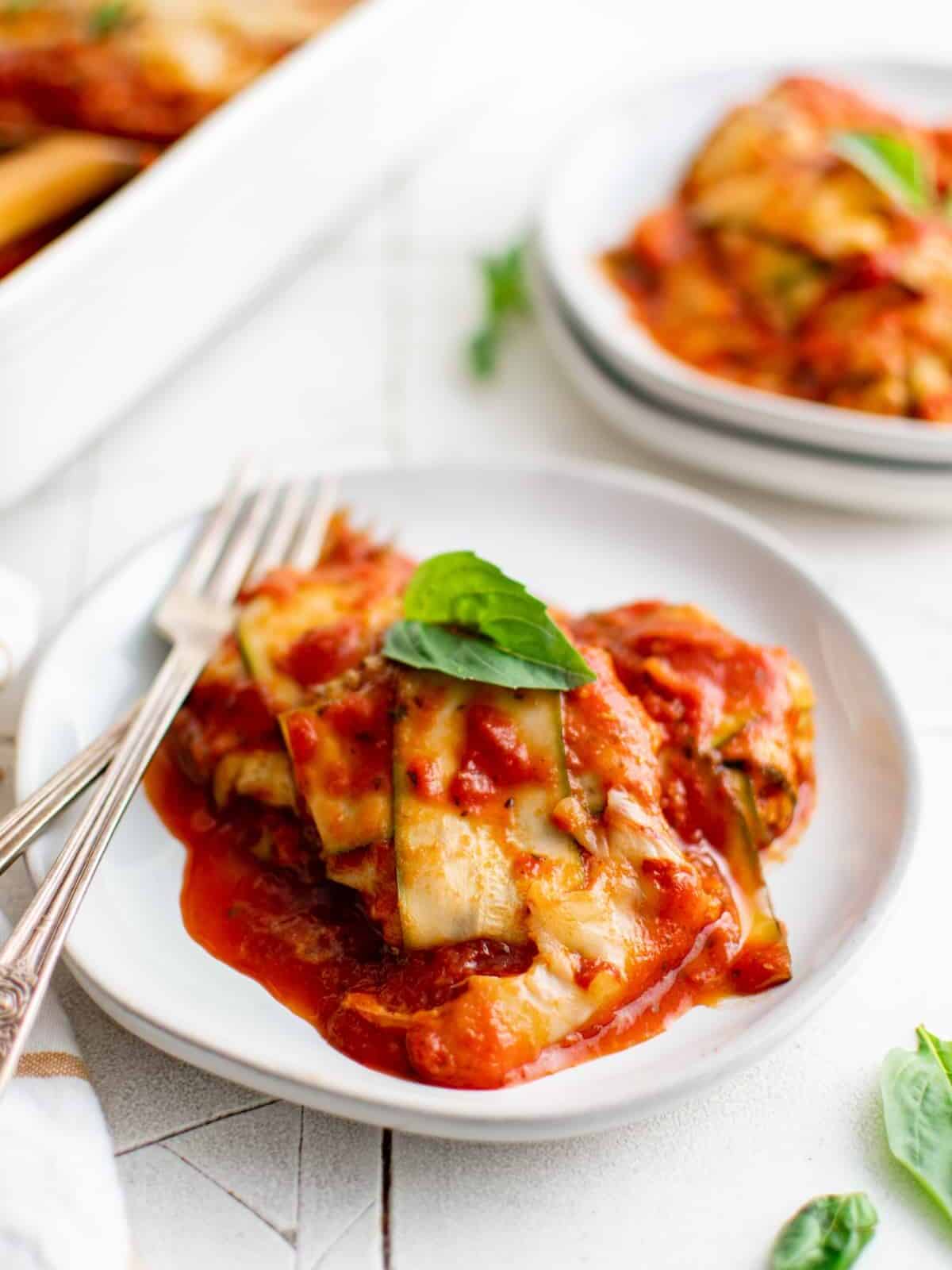 a small plate of zucchini ravioli in marinara sauce