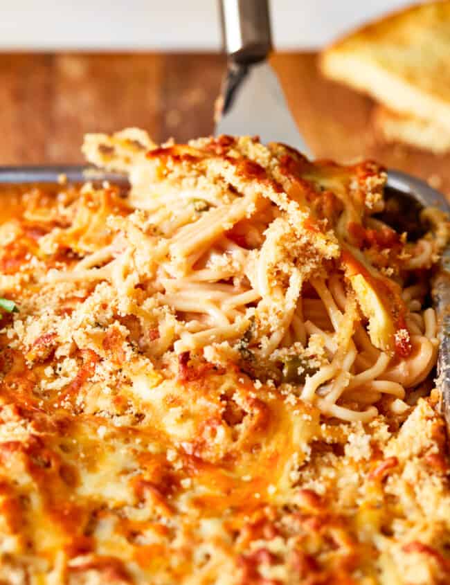 a dish of spaghetti and meatballs in a baking dish.