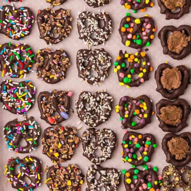 overhead image of chocolate covered pretzels with toppings