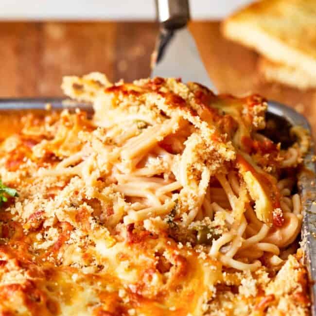 a dish of spaghetti and meatballs in a baking dish.