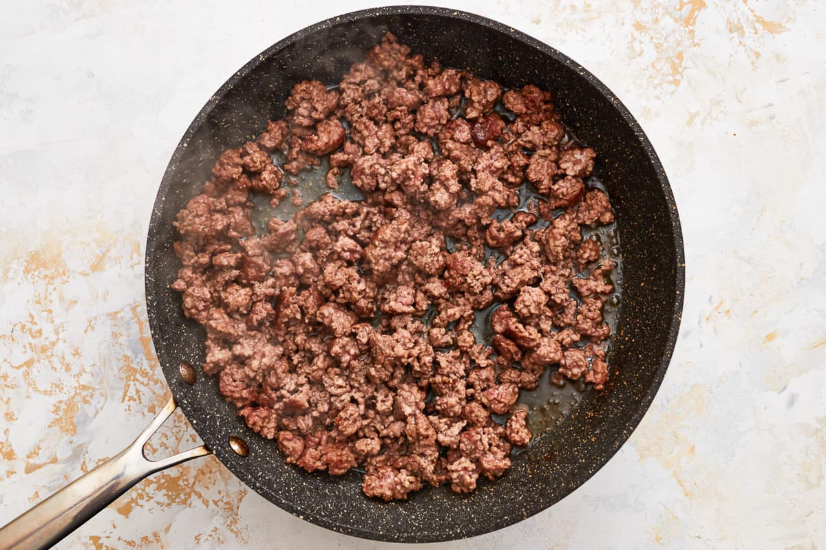 Ground chuck browning in a skillet.