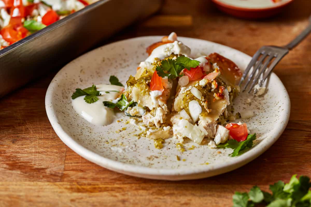 mexican enchiladas on a plate with a fork.