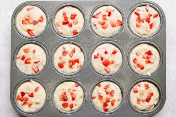 strawberry muffins in a muffin tin.