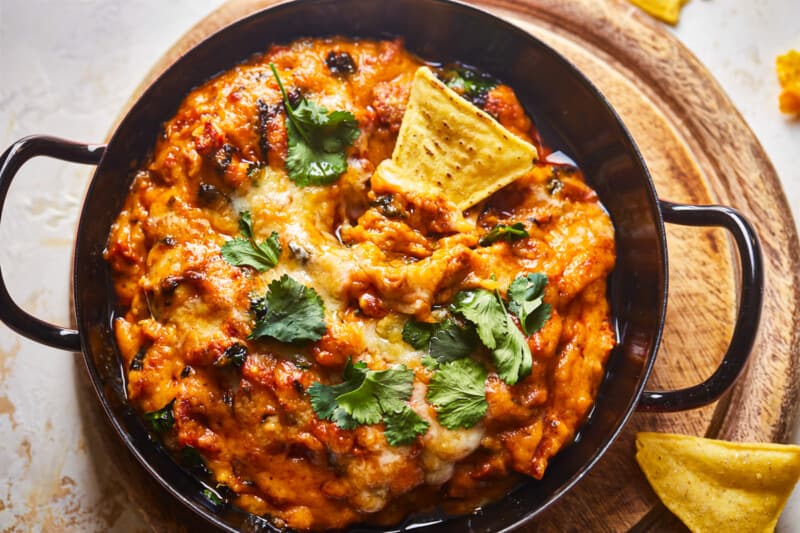 mexican dip in a skillet with tortilla chips.