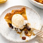 a slice of pie with ice cream on a plate.