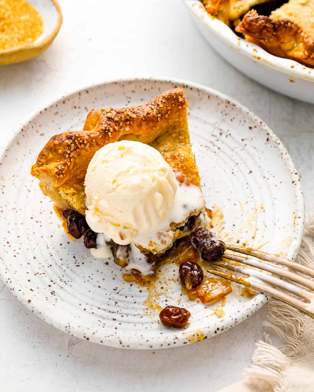 a slice of pie with ice cream on a plate.