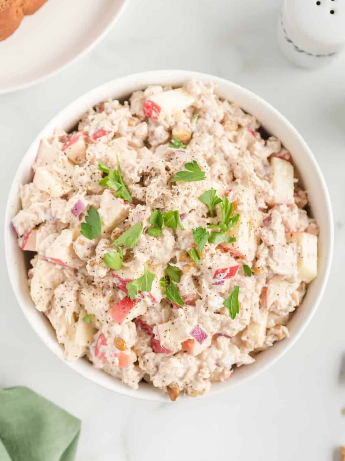 overhead view of classic tuna salad in a white bowl.