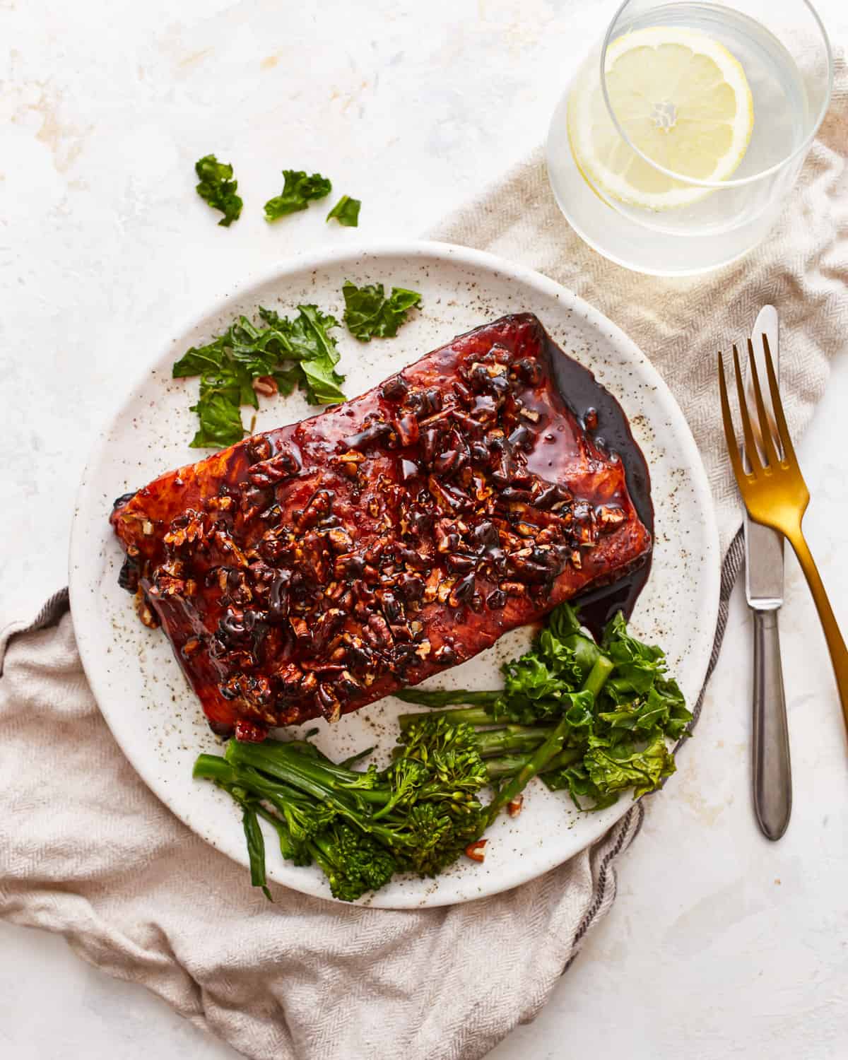 overhead view of a bourbon brown sugar glazed salmon filet with broccolini.