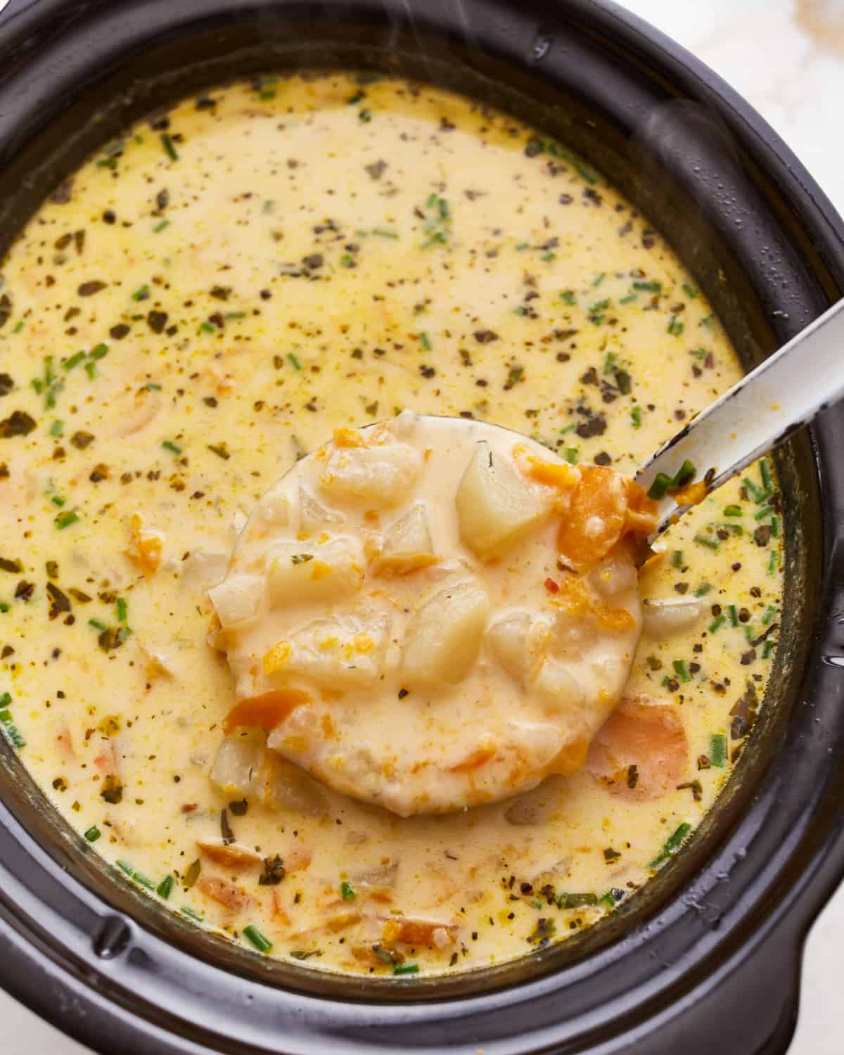 A bowl of soup with a spoon in it.