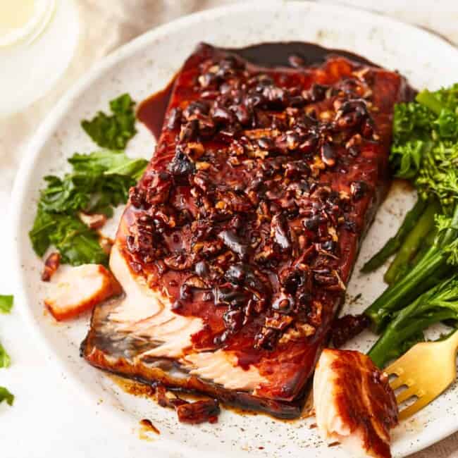 A plate with salmon and broccoli on it.