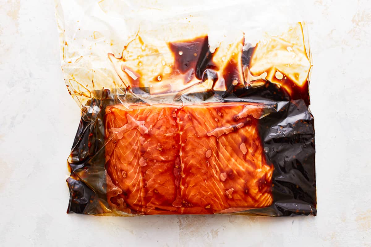 salmon marinating in bourbon brown sugar sauce in a Ziplock bag.