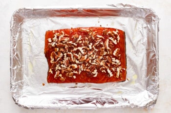 Smoked salmon with pecans on tin foil.