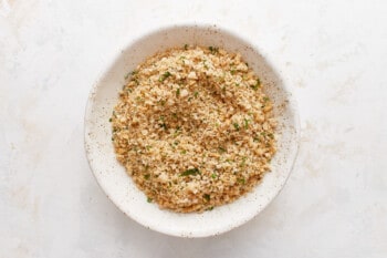 A bowl filled with a mixture of herbs and spices.