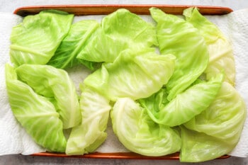 Cabbage leaves on a baking sheet.