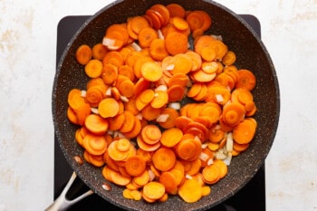 Sliced carrots in a frying pan.