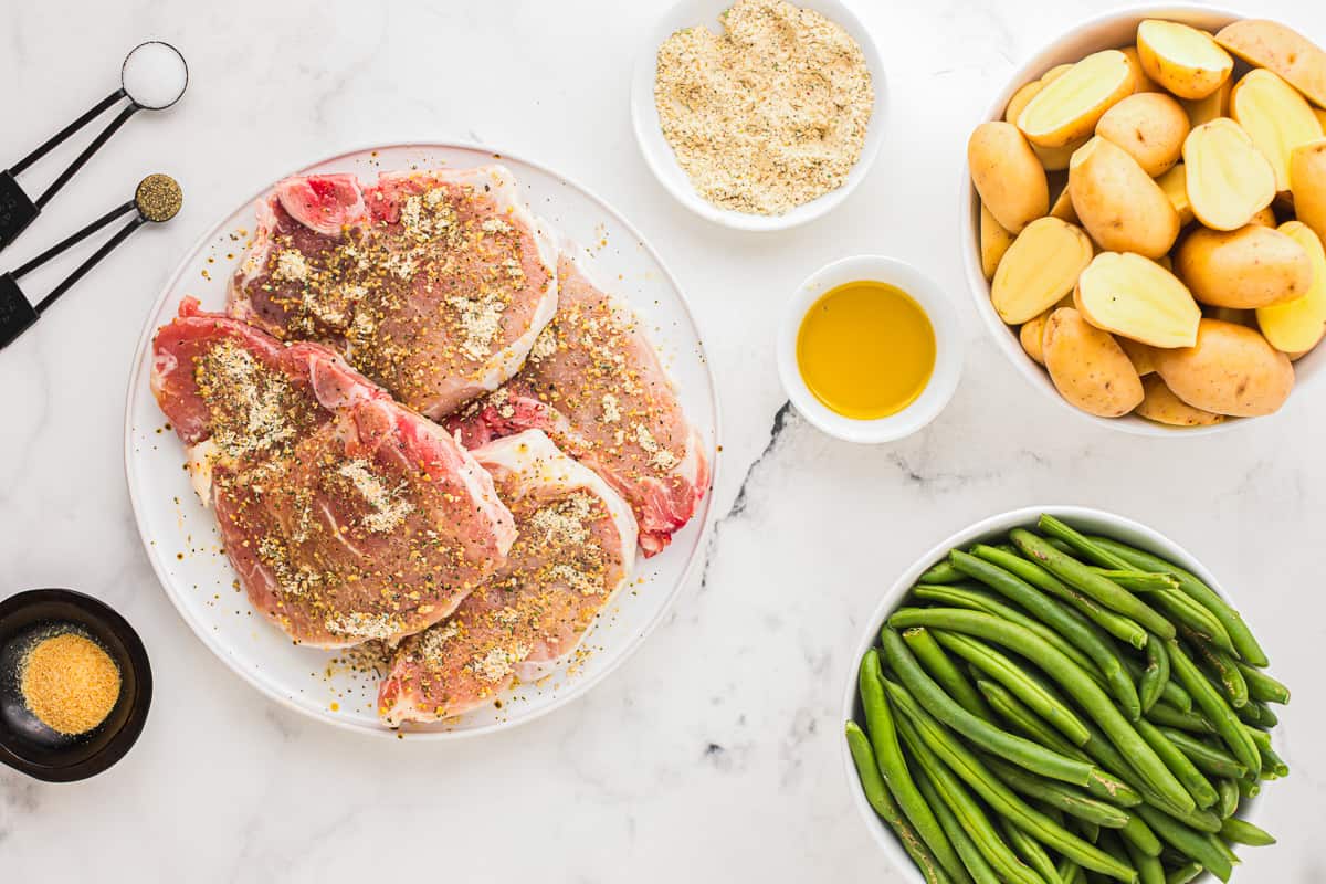 Pork chops coated in a seasoning mixture.