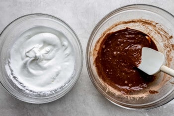 Two bowls with chocolate and whipped cream in them.