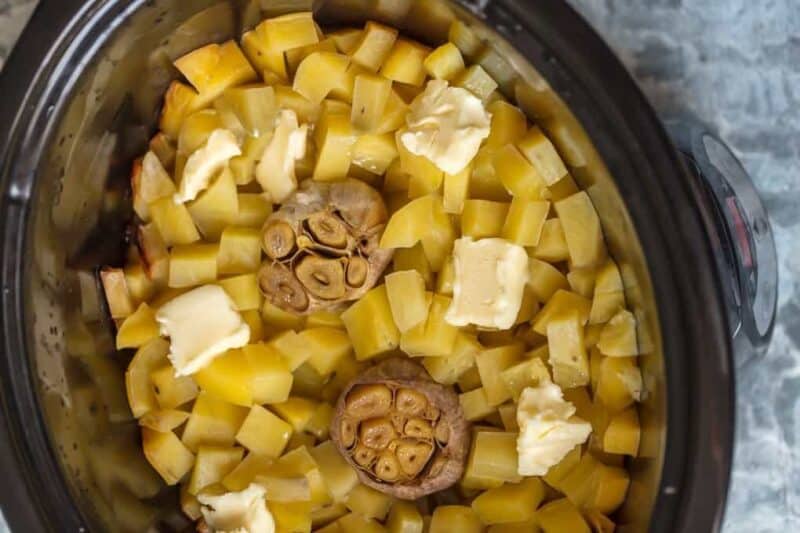 Potatoes, garlic, and butter in a crock pot