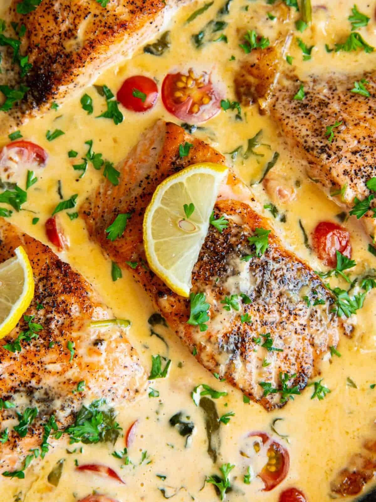 close up view of tuscan salmon in a cast iron skillet