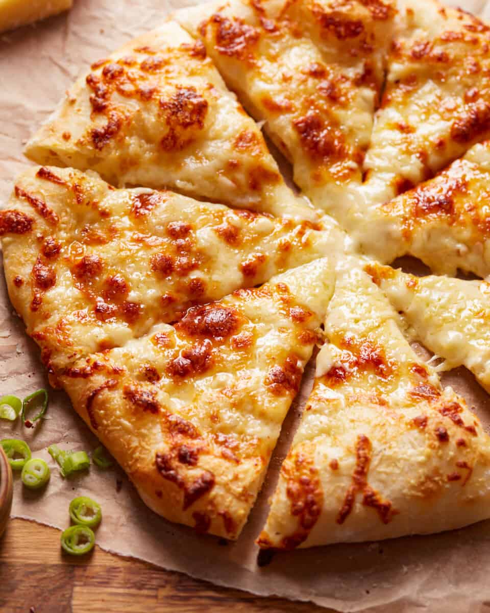 Alfredo pizza cut into slices.