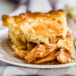 apple pie on a plate with a gray towel