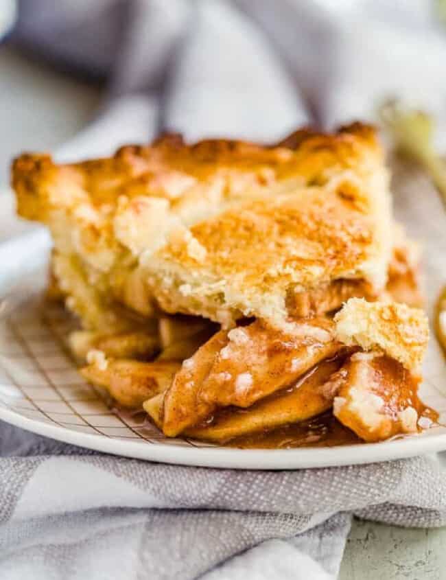 apple pie on a plate with a gray towel