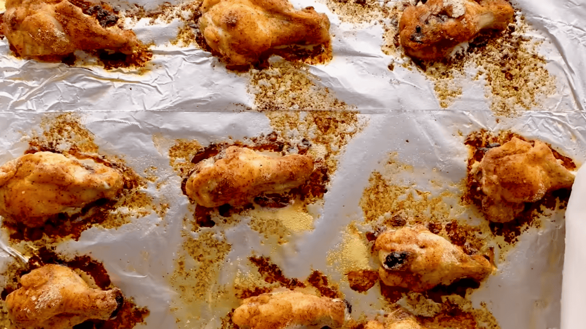 baked chicken wings on a foil lined baking sheet.