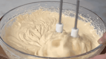 beating caramel apple dip with a hand mixer.