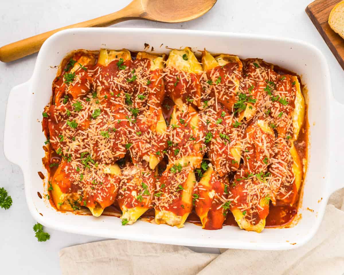 Stuffed pasta shells in a white baking dish.