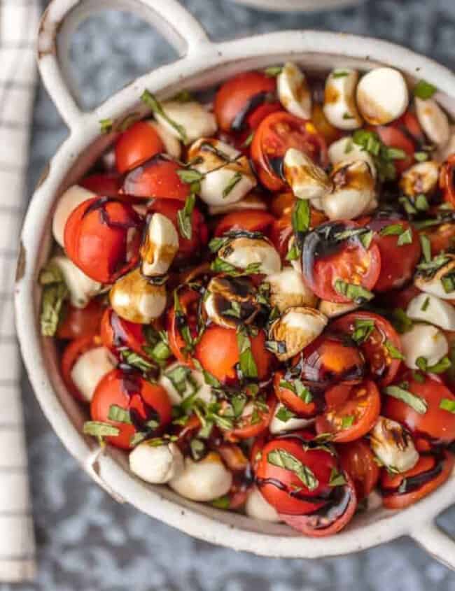 up close caprese salad in white bowl