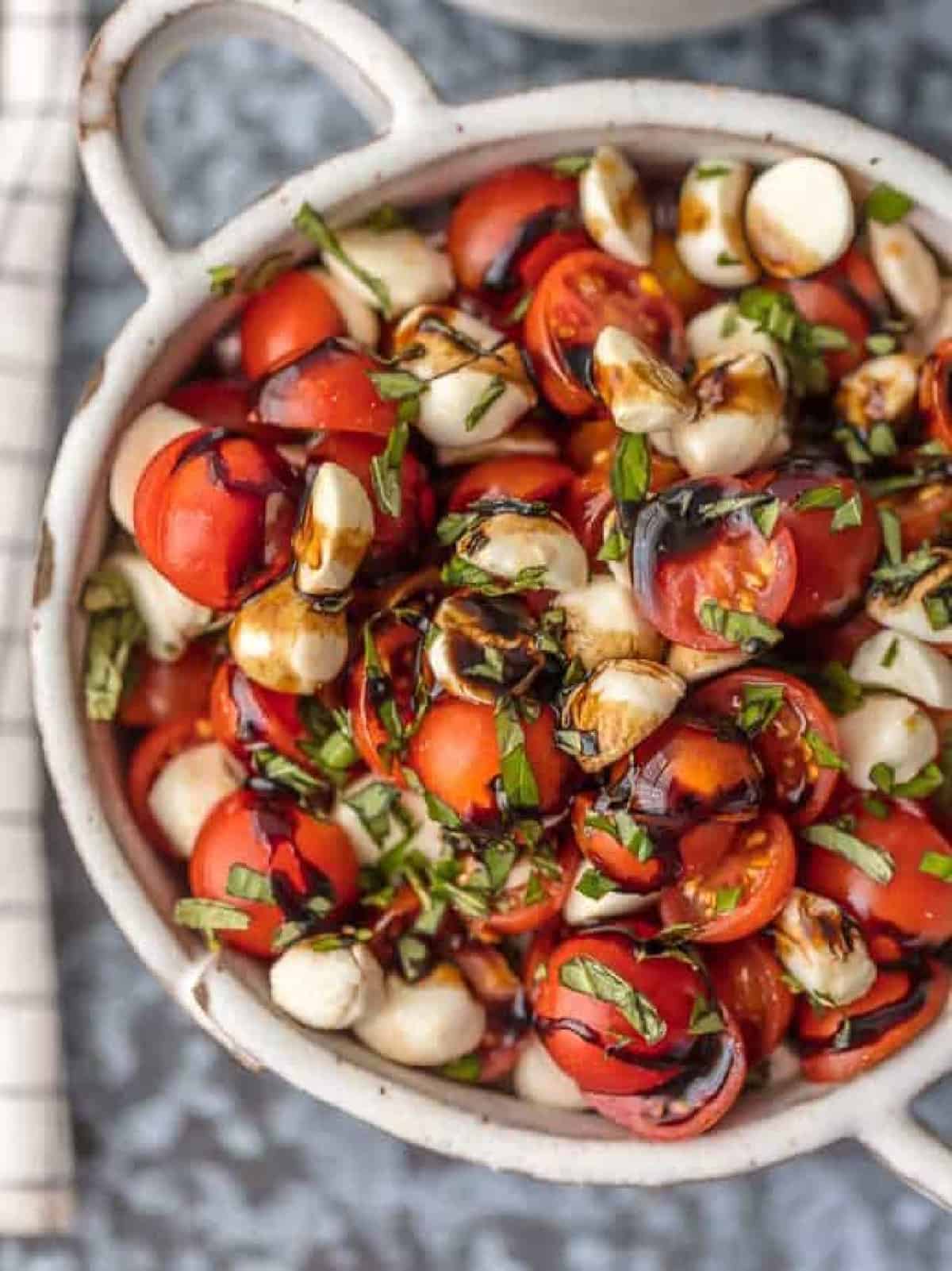 up close caprese salad in white bowl