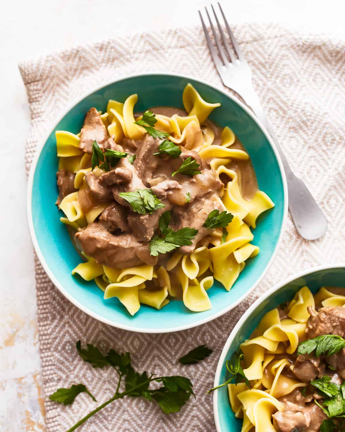 Two bowls of beef and noodles.