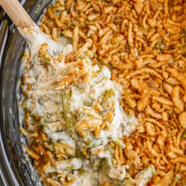 overhead wooden spoon in crockpot green bean casserole