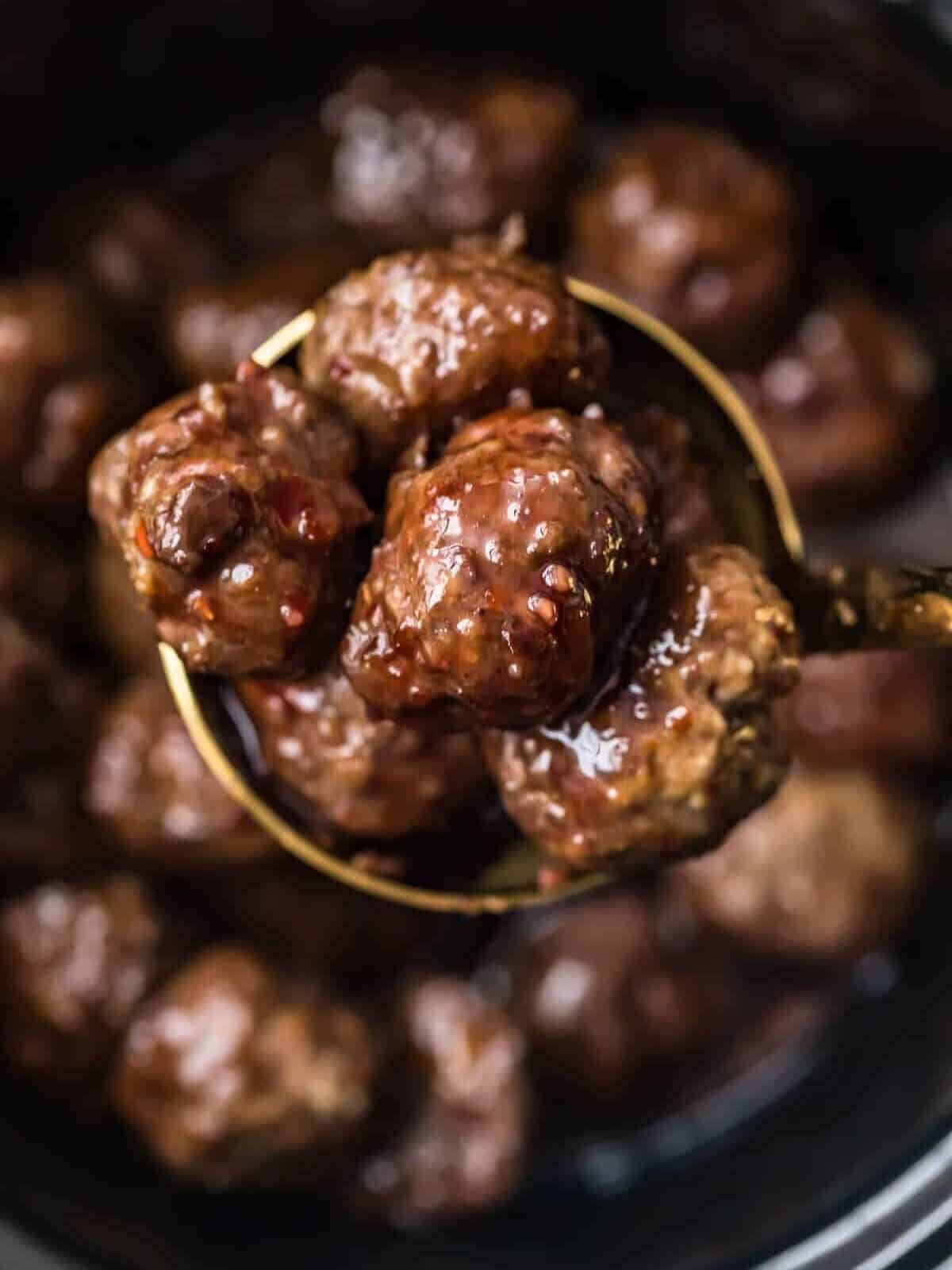 grape jelly meatballs in a spoon