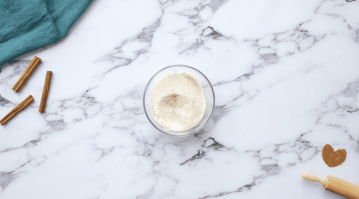 sugar, flour, and cinnamon mixed in a small glass bowl.