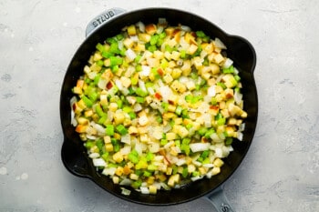 A skillet filled with green beans and onions.