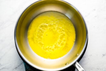 Eggs in a pan on a marble countertop.