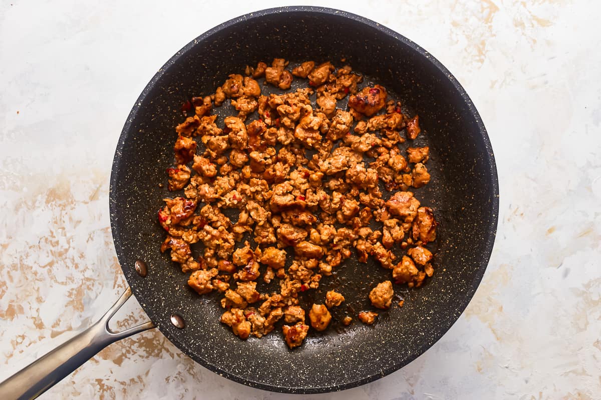 Sausage browning in a skillet.