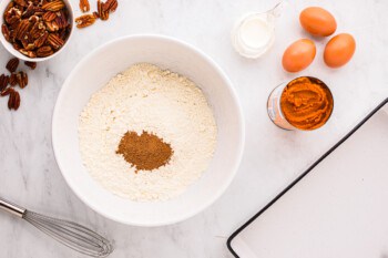 A white bowl with ingredients on it.