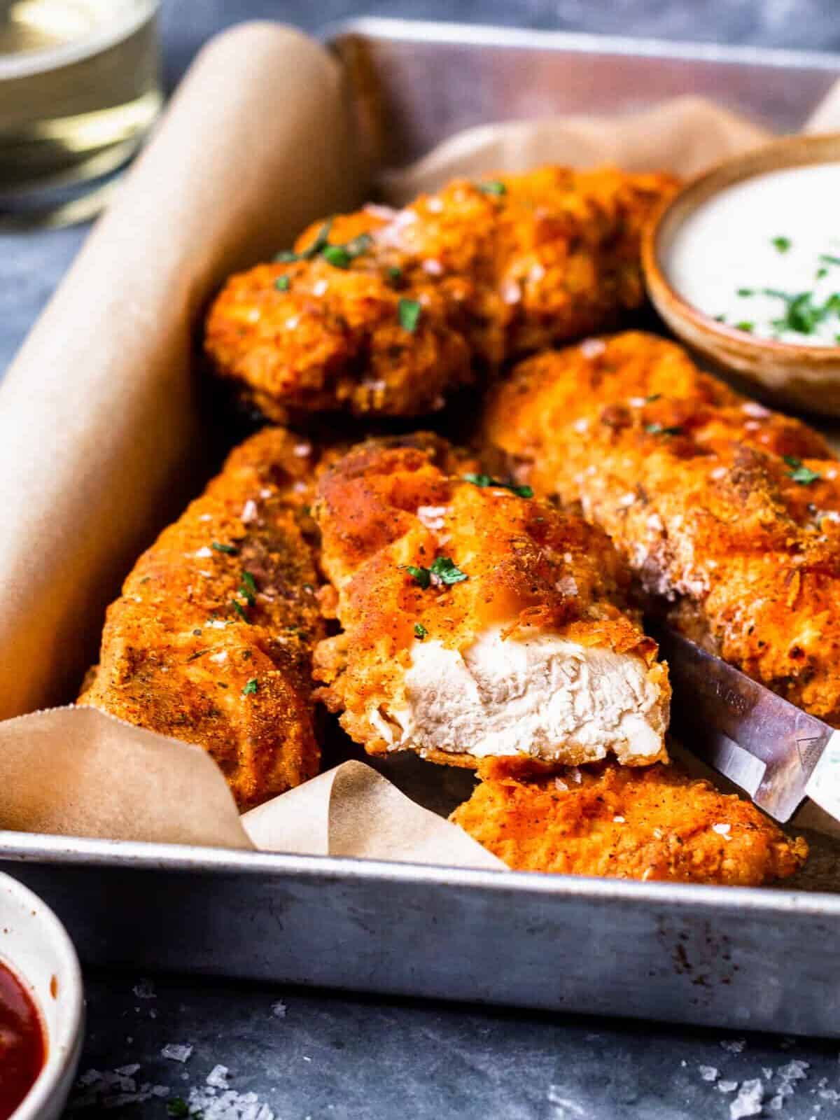 pieces of crispy breaded chicken breast on a tray