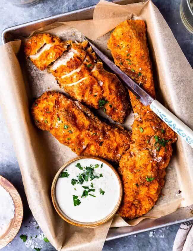 four pieces of oven fried chicken on a tray