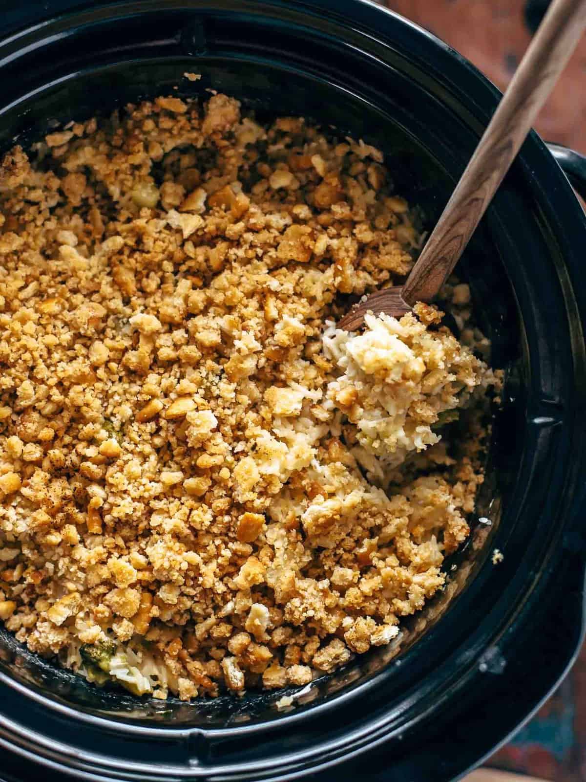 A crock pot full of granola with a wooden spoon, but replace "granola" with "velveeta" and "wooden spoon" with "broccoli rice casserole.