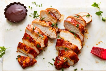 Bbq sliced chicken on a cutting board.