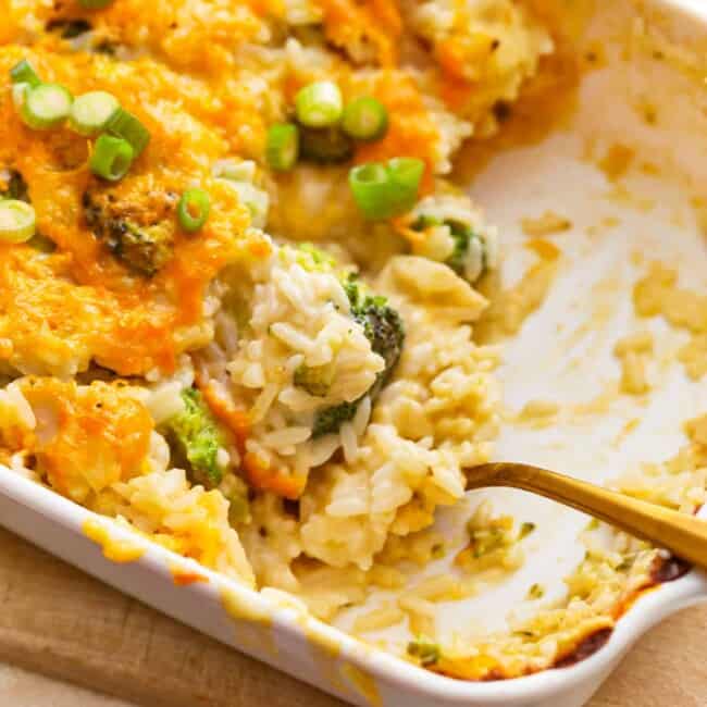 A casserole dish with broccoli and rice in it.