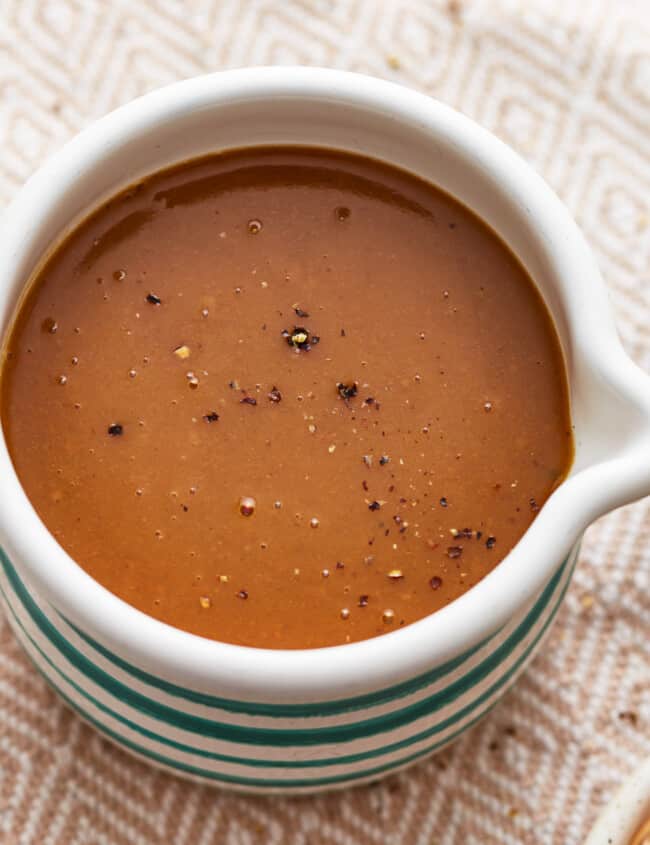 A bowl of make ahead turkey gravy on a table.