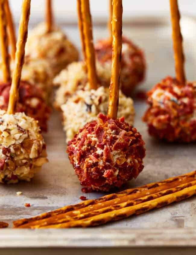 mini cheese ball bites with pretzel sticks.