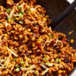 A skillet filled with taco mac and cheese.